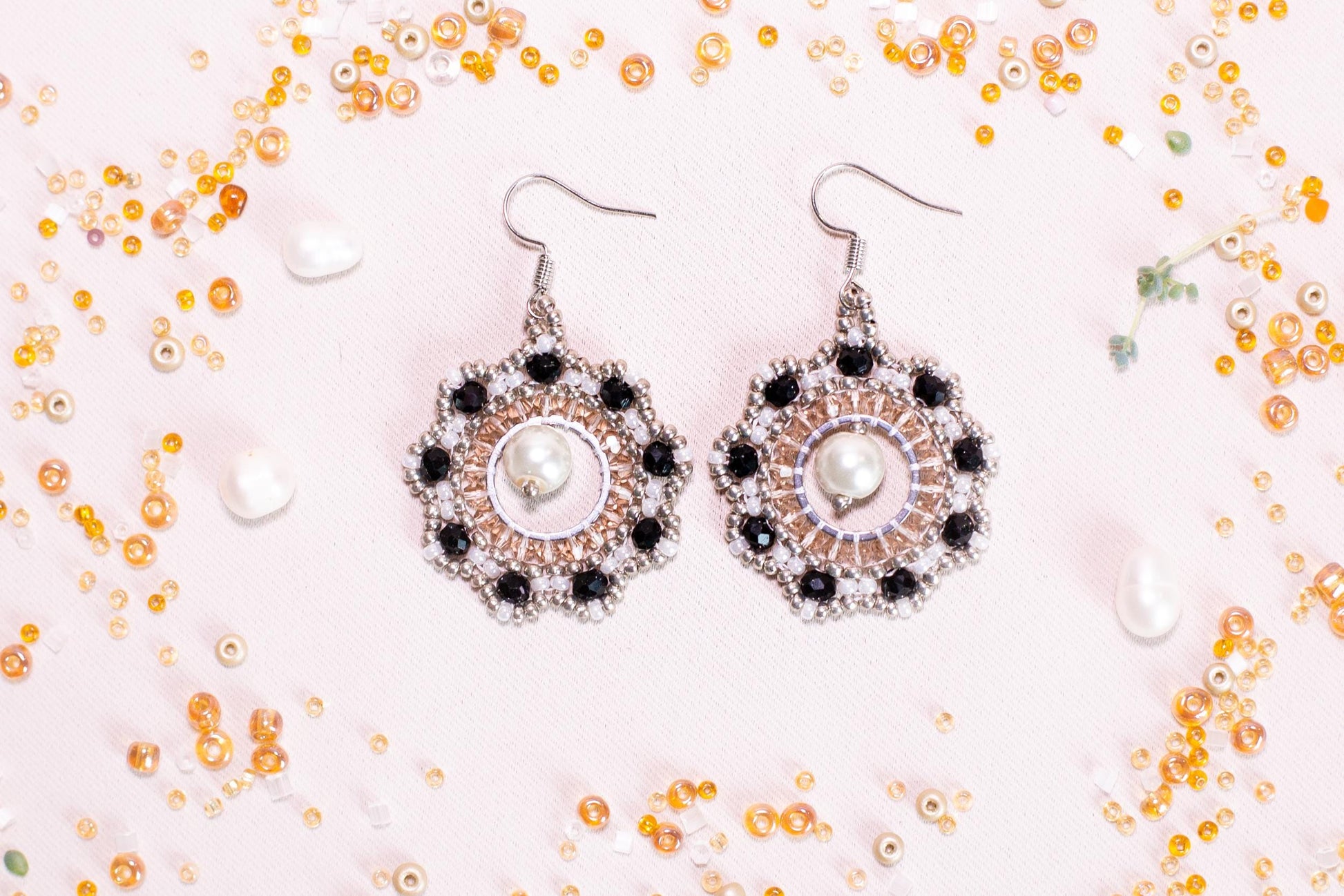 a pair of earrings sitting on top of a table