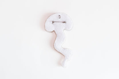 a white piece of cloth with a hook on it