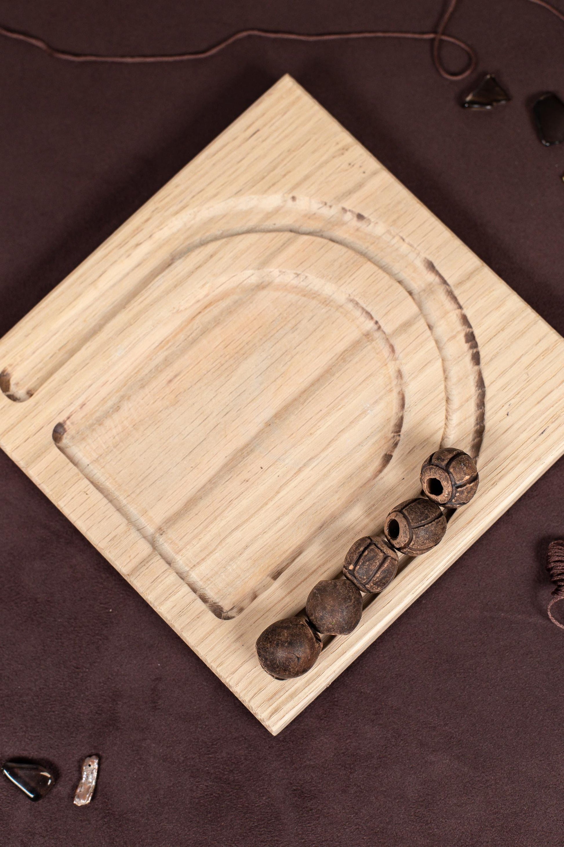 a wooden board with a string of skulls on it