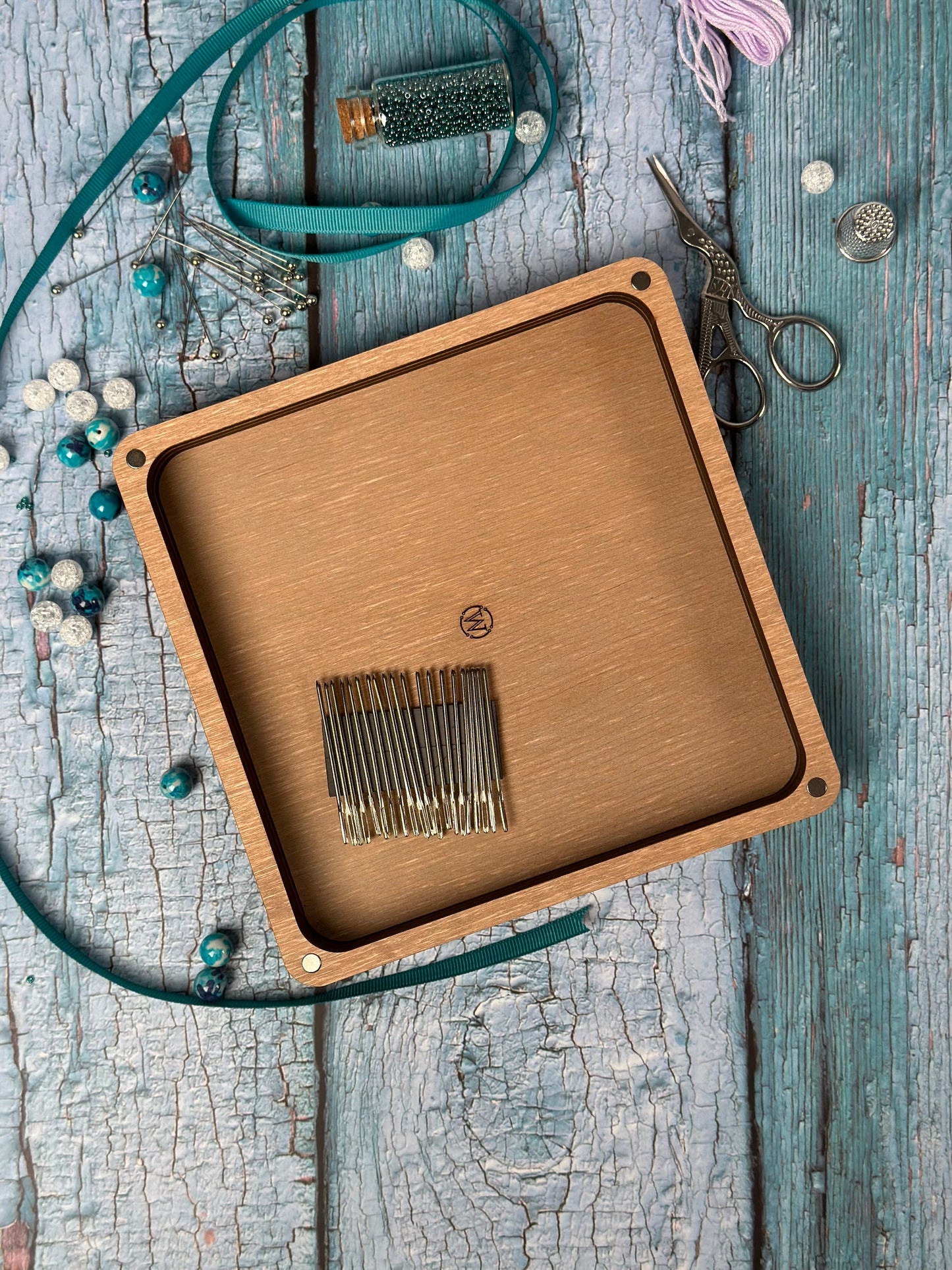 a wooden box with a metal comb inside of it