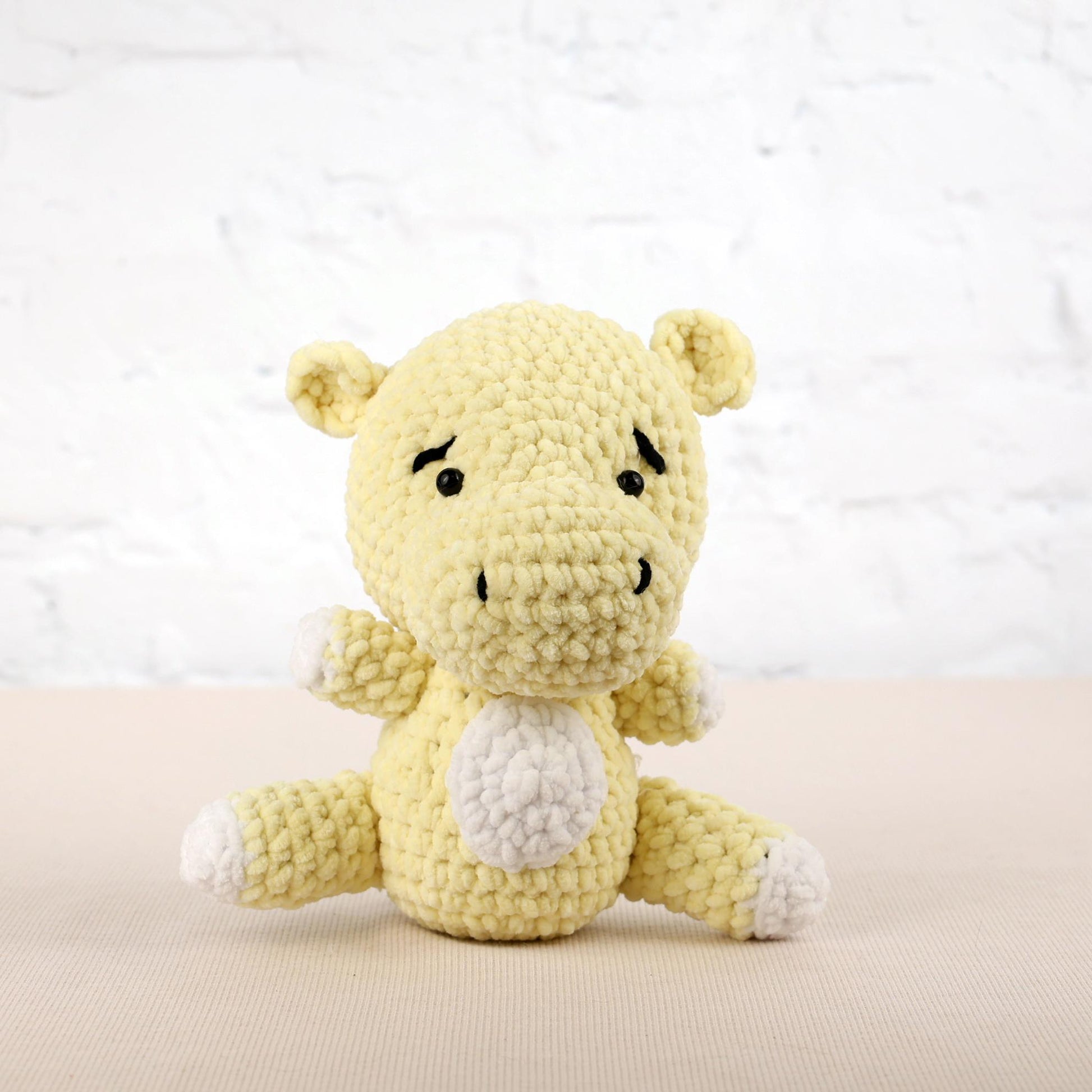 a small yellow stuffed animal sitting on a table