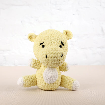 a small yellow stuffed animal sitting on a table