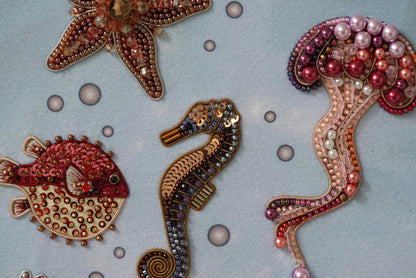 a group of seahorses made out of beads