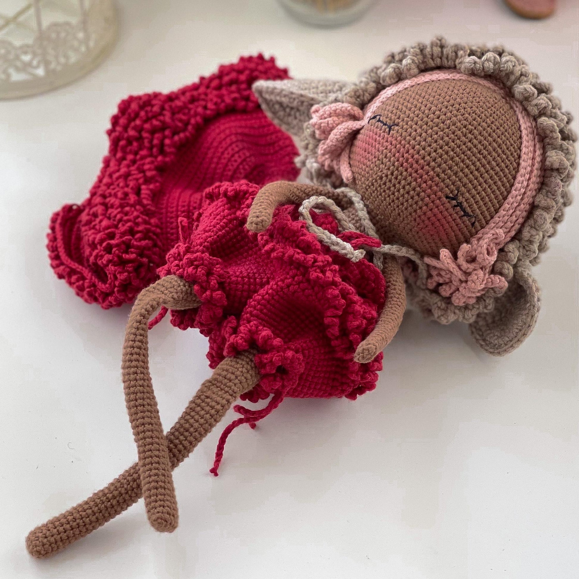 a knitted doll laying on top of a table