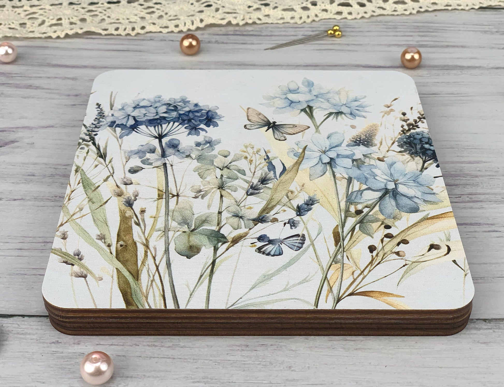 a coaster with a painting of flowers on it