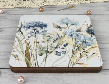 a coaster with a painting of flowers on it
