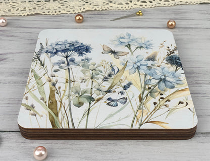 a coaster with a painting of flowers on it