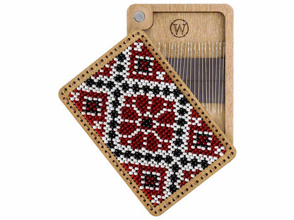 a wooden comb with a red and black design on it