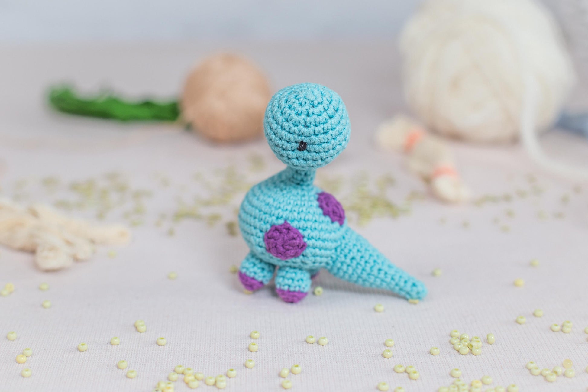 a small crocheted figure sitting on top of a table