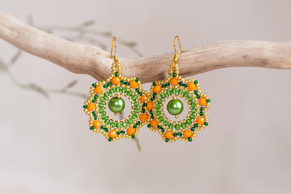 a pair of green and orange beaded earrings