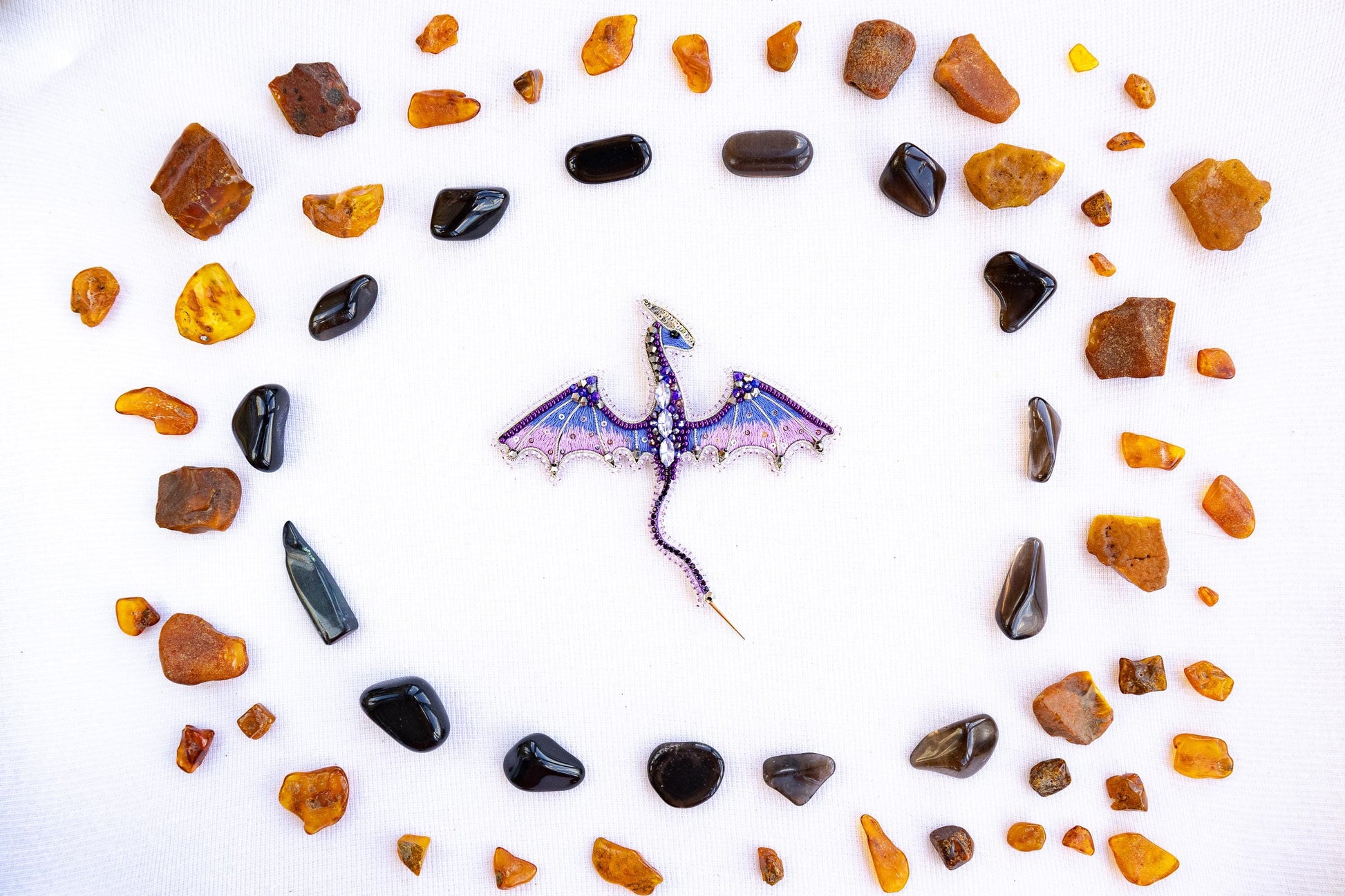 a clock made out of rocks and a dragon figurine