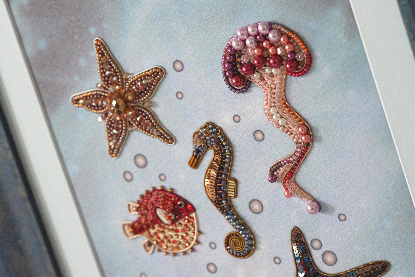 a picture of a seahorse, starfish, and seahorse broochies