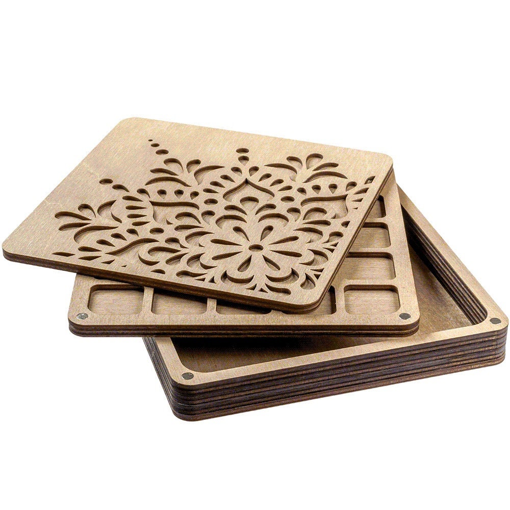 a stack of wooden coasters with a flower design