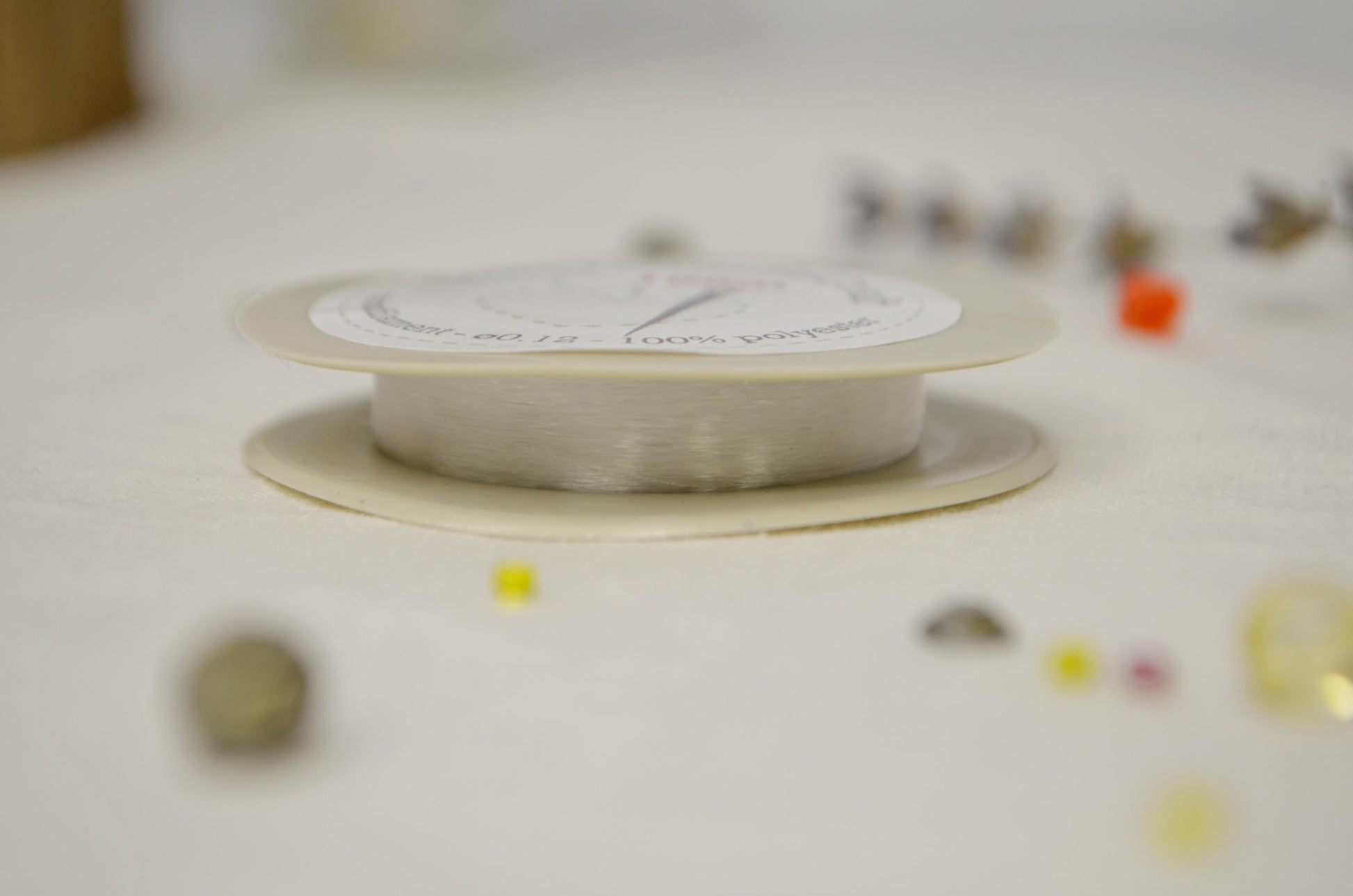 a spool of white thread sitting on top of a table