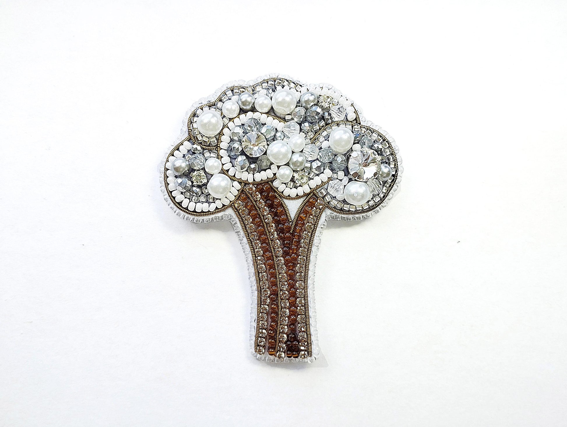 a brooch with a tree made of pearls