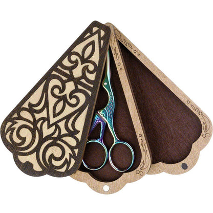 a pair of scissors sitting inside of a wooden case
