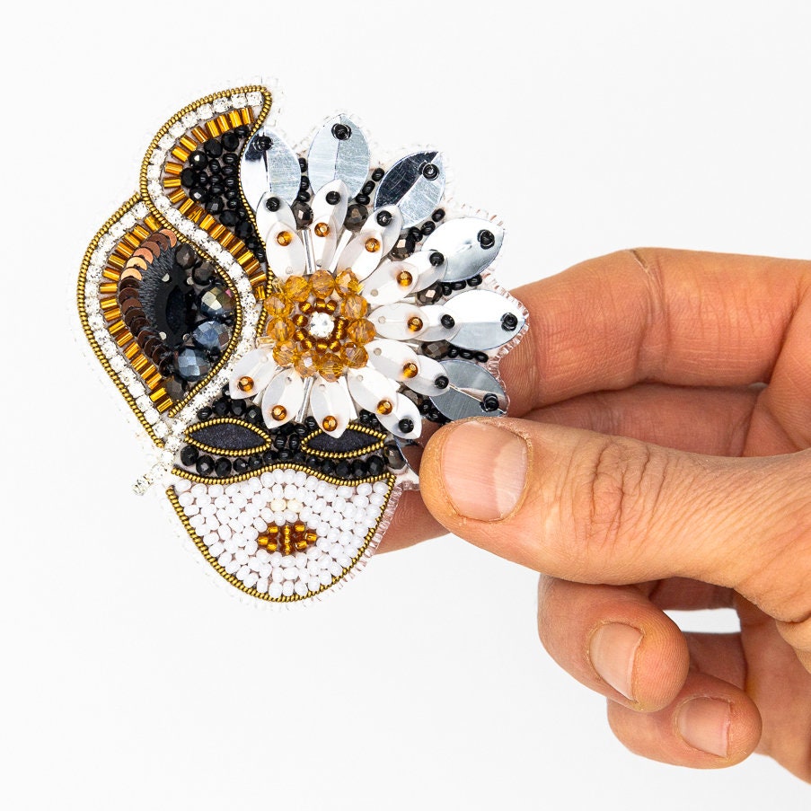 a hand is holding a small decorative object