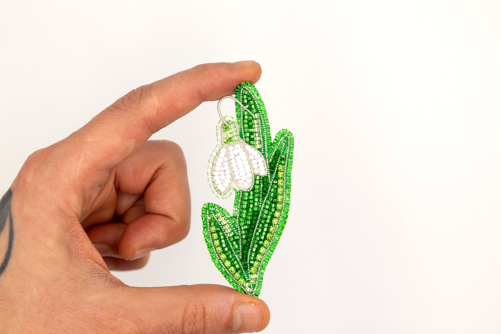 a hand holding a piece of string art