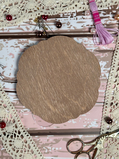 a piece of wood sitting on top of a table next to a pair of scissors