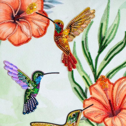 a painting of a hummingbird and flowers in a frame