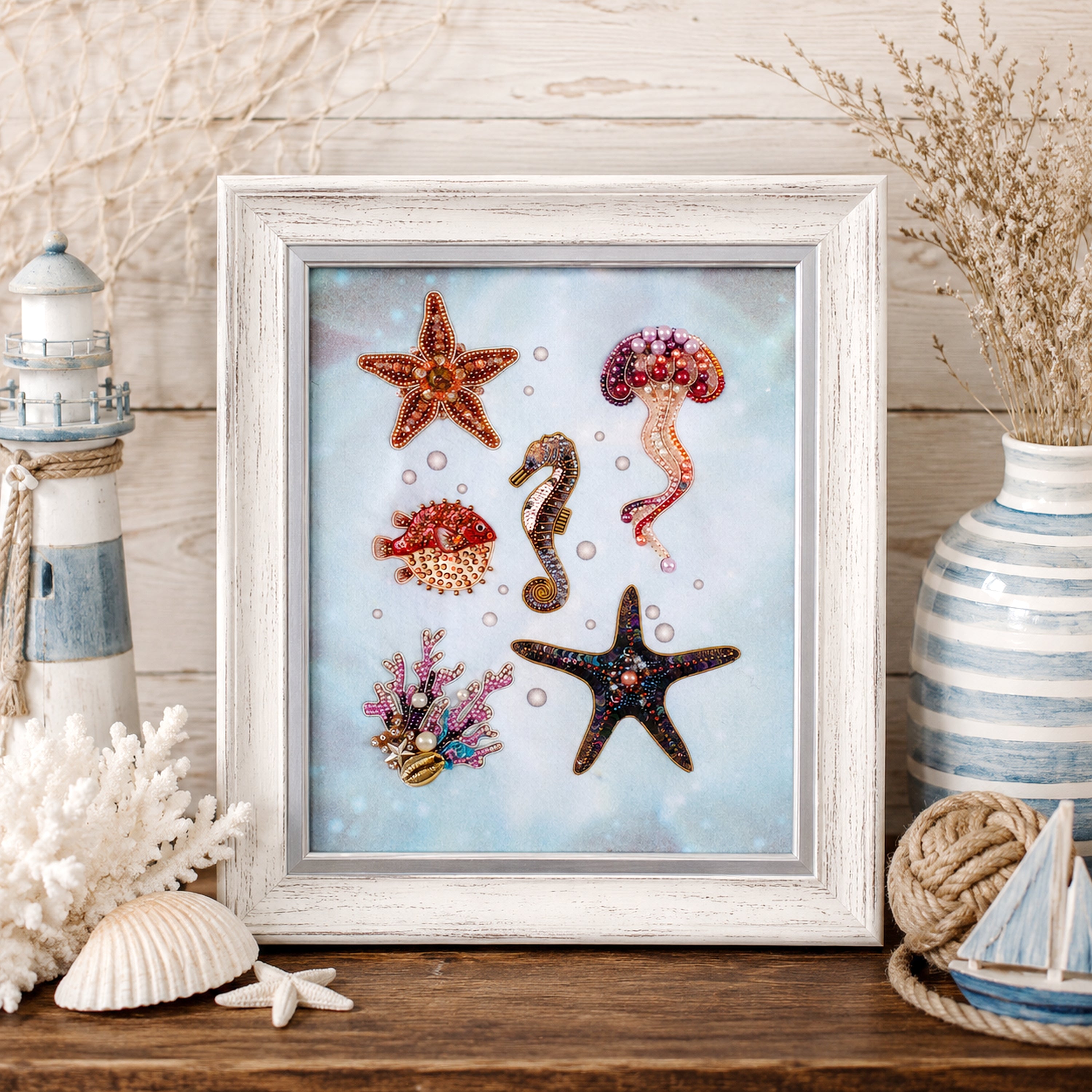 A framed collage of various marine life, including a starfish, jellyfish, and seahorse, is displayed on a wooden surface.
