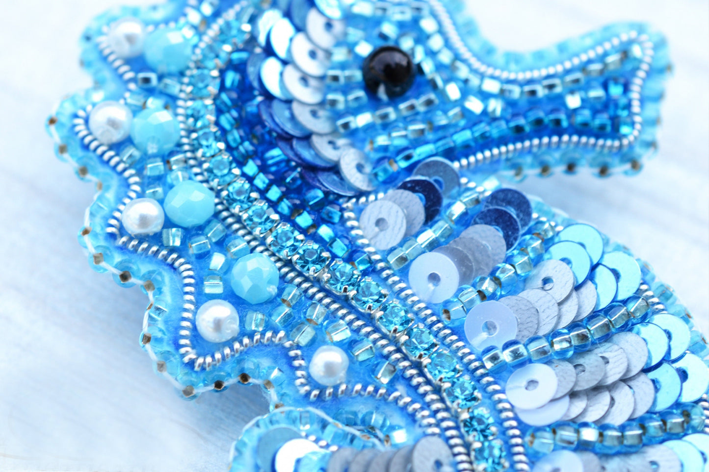 a close up of a cell phone case made out of beads