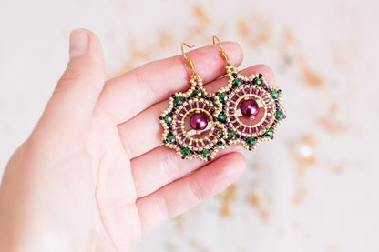 a person holding a pair of earrings in their hand