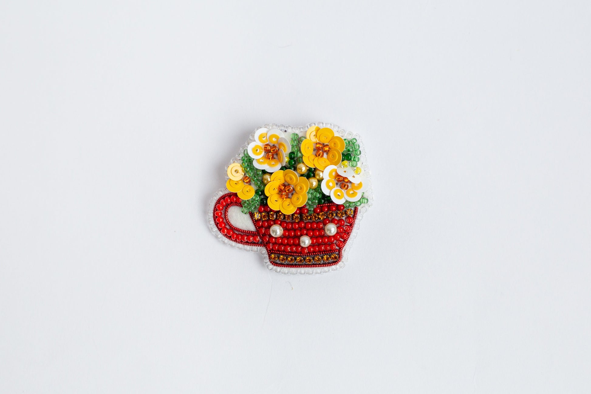 a picture of a red teacup with flowers in it