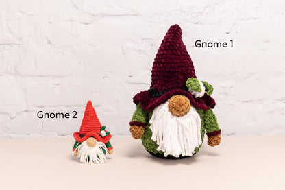 two crocheted gnomes sitting next to each other