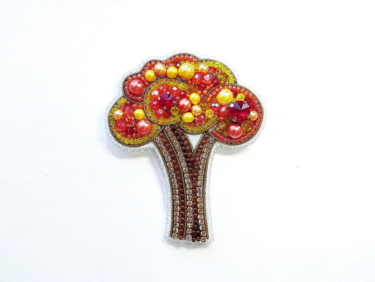 a brooch with a tree made of beads