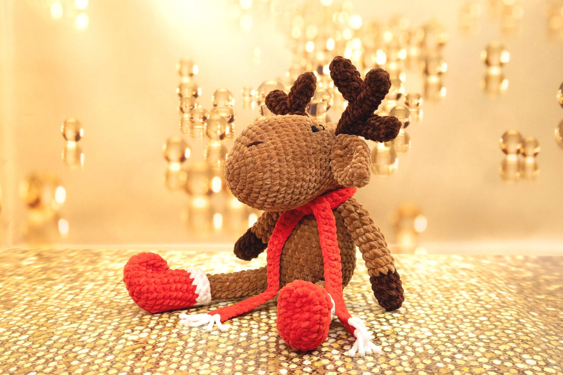 a crocheted stuffed animal with a red heart