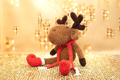 a crocheted stuffed animal with a red heart