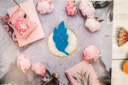 a picture of a blue bird sitting on top of a table