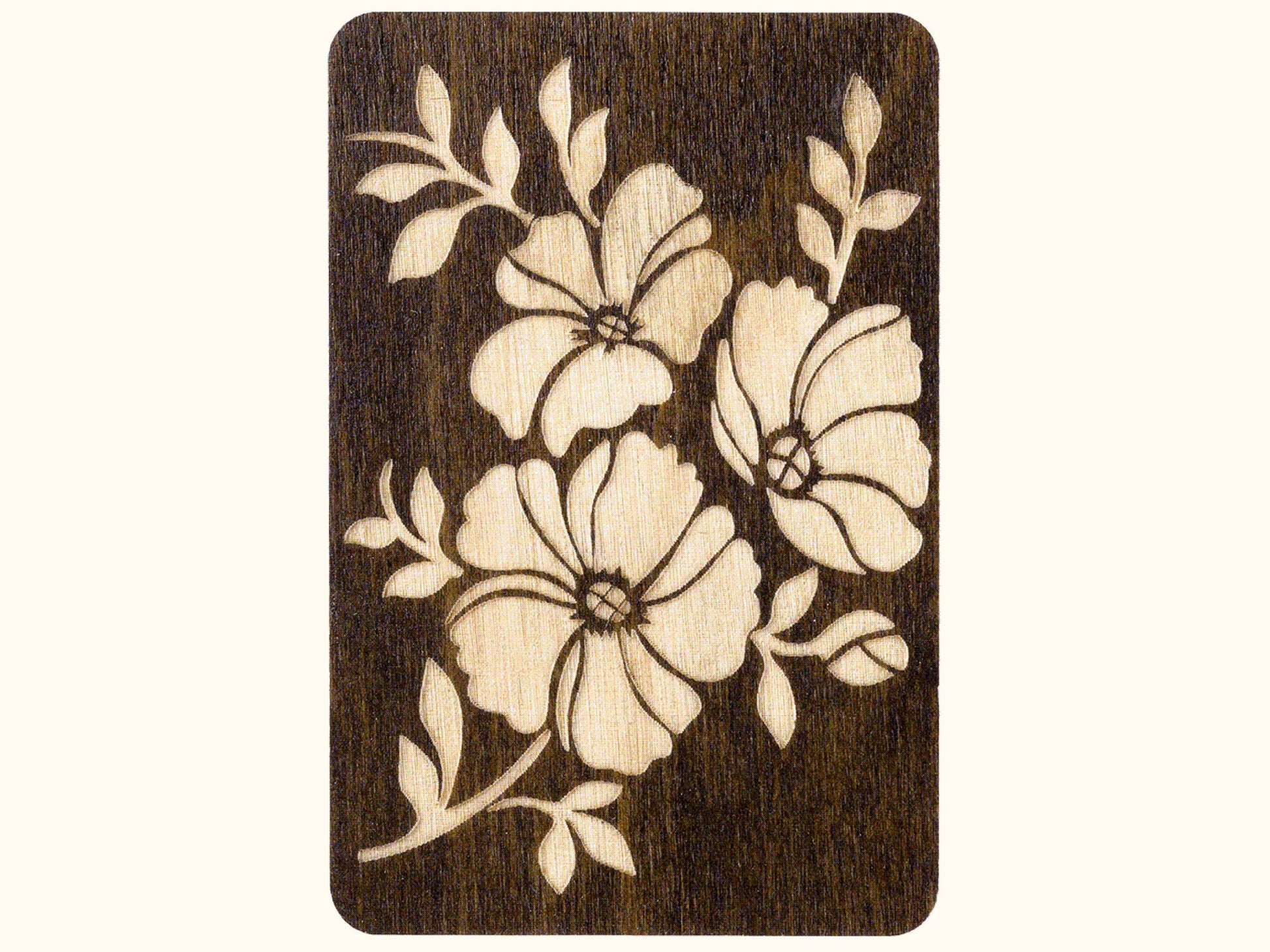 a wooden card with a flower design on it