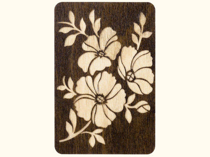 a wooden card with a flower design on it