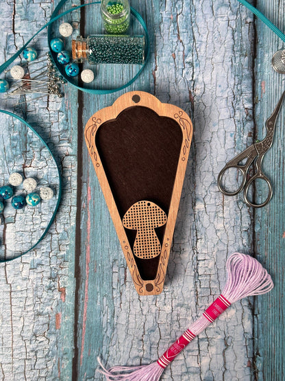 a pair of scissors and a wooden case on a table