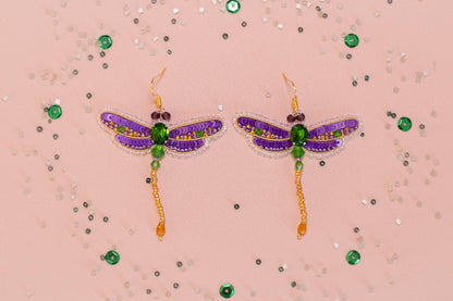 a pair of purple and green dragonfly earrings