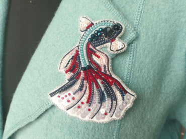 a close up of a person wearing a blue jacket with a red, white and