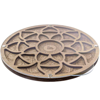 a wooden coaster with a flower design on it