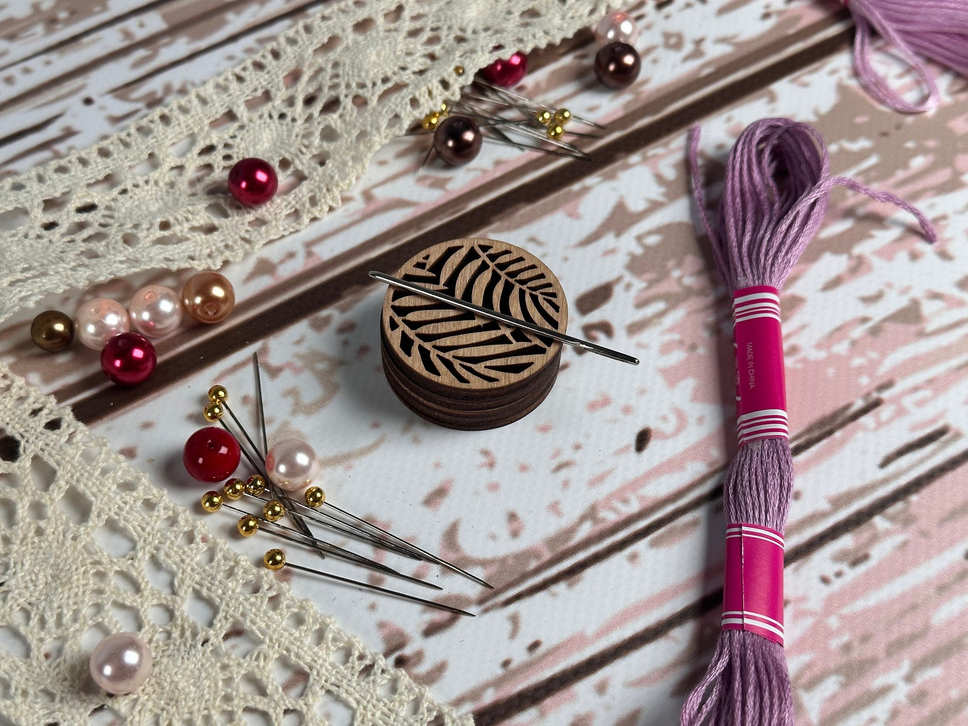 a pair of knitting needles and a wooden box on a table