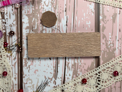 a wooden sign sitting on top of a white wall