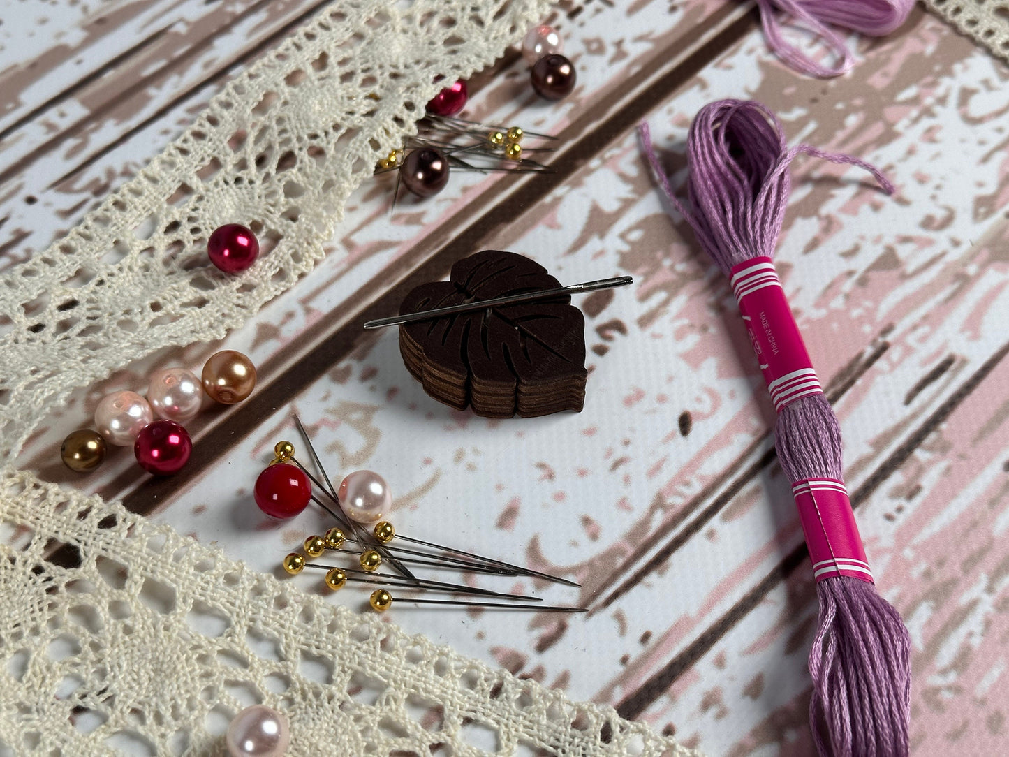 a close up of a table with beads and a pen