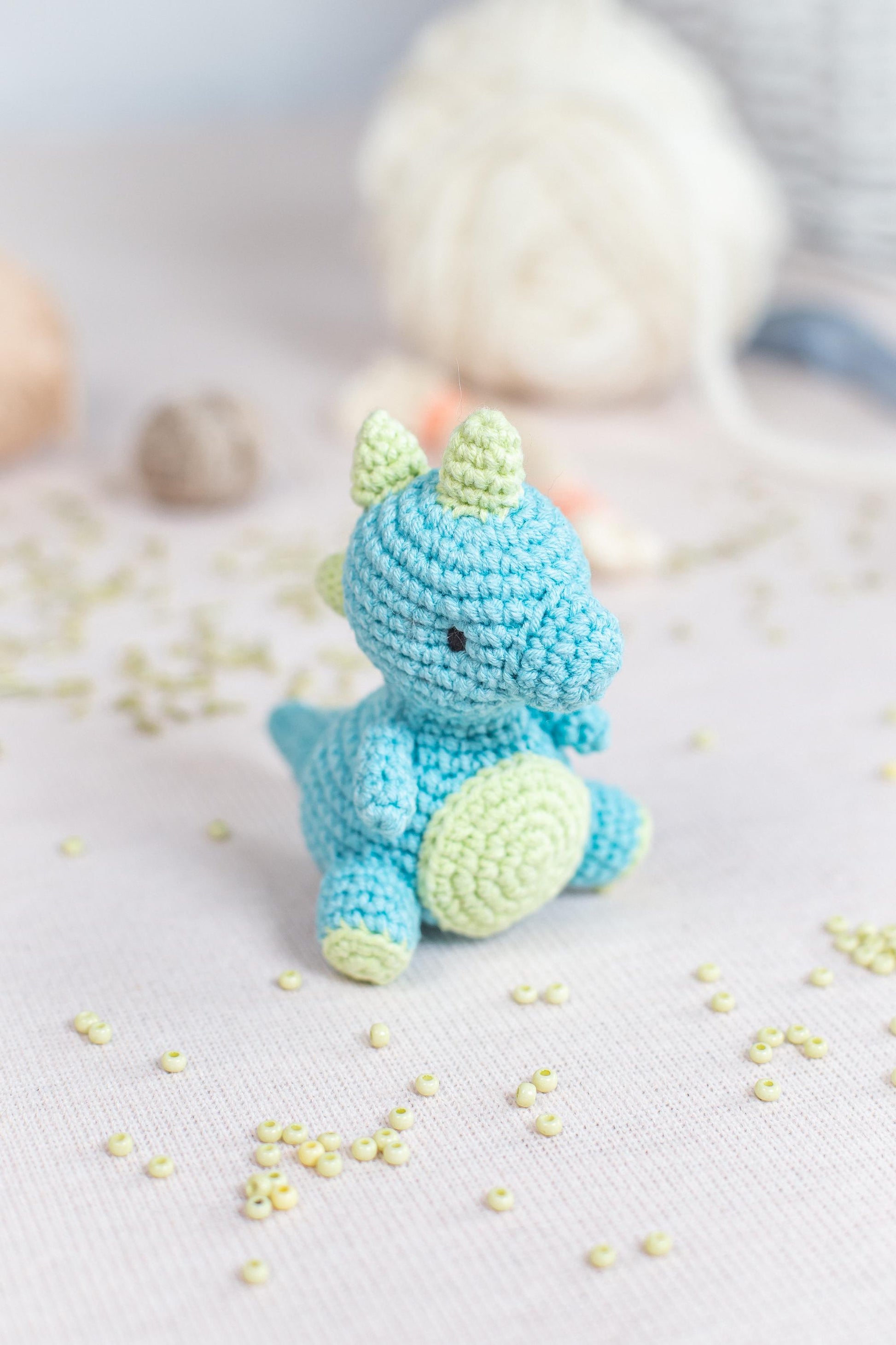 a crocheted stuffed animal sitting on top of a bed