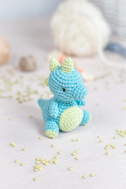 a crocheted stuffed animal sitting on top of a bed