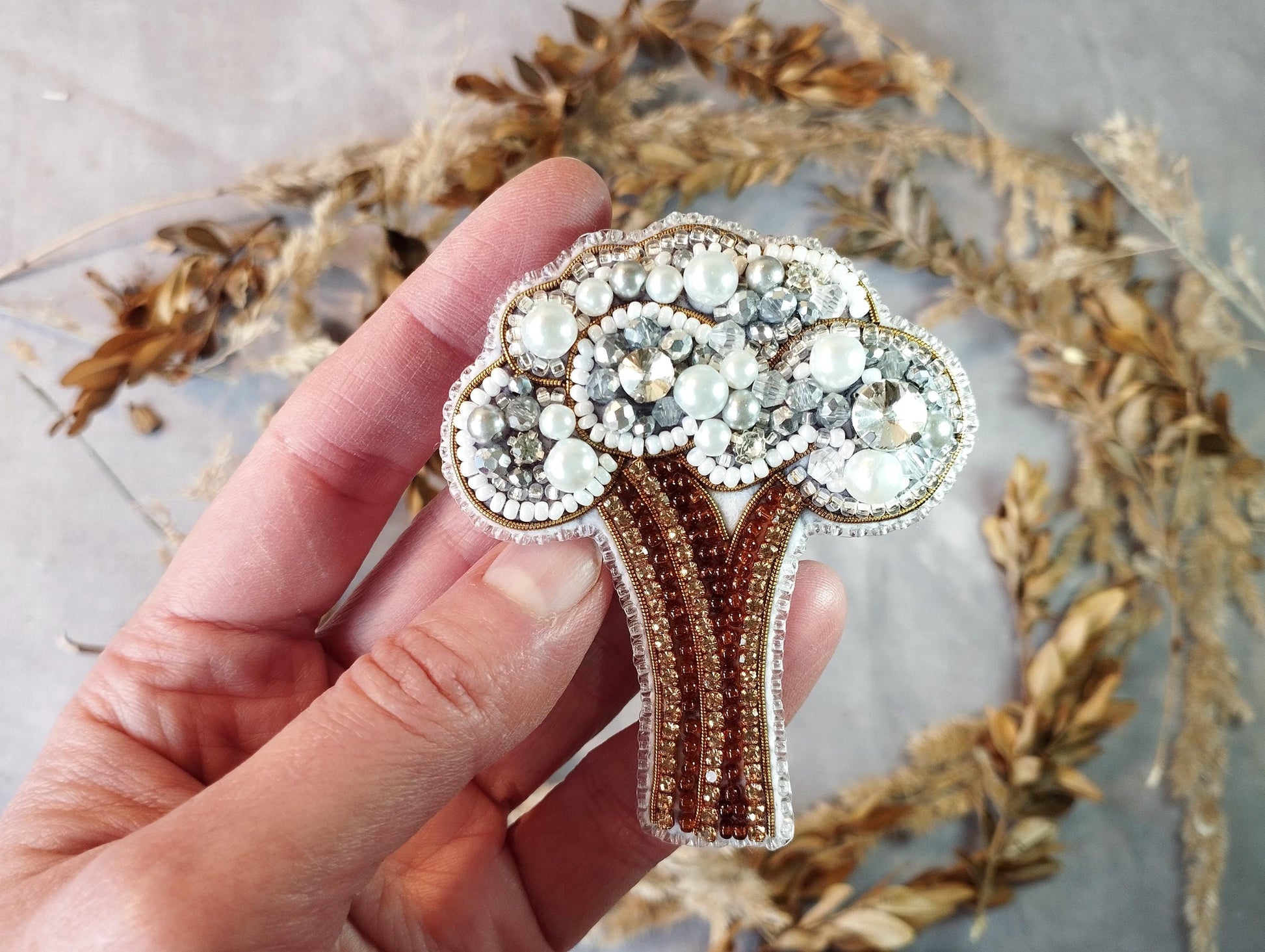 a person holding a brooch in their hand