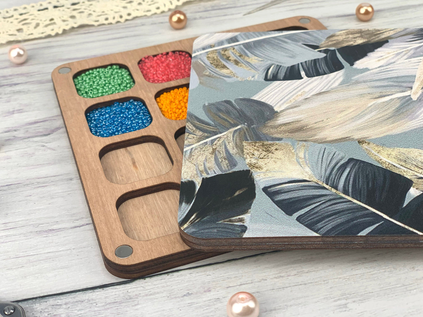 a wooden tray with paint and some beads