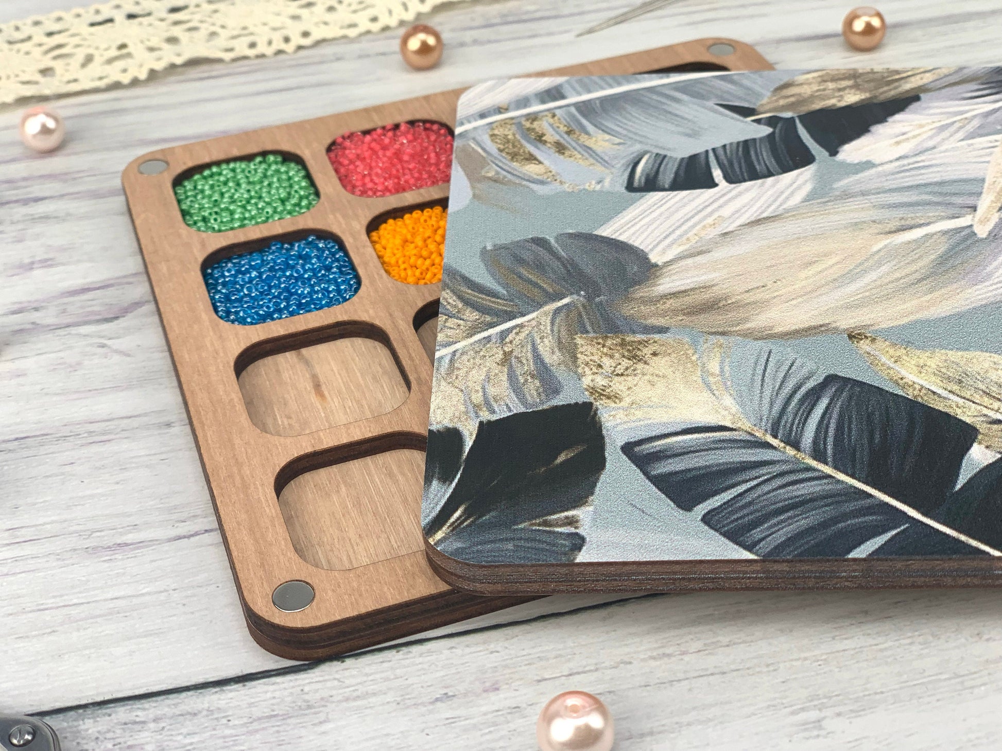 a wooden tray with paint and some beads