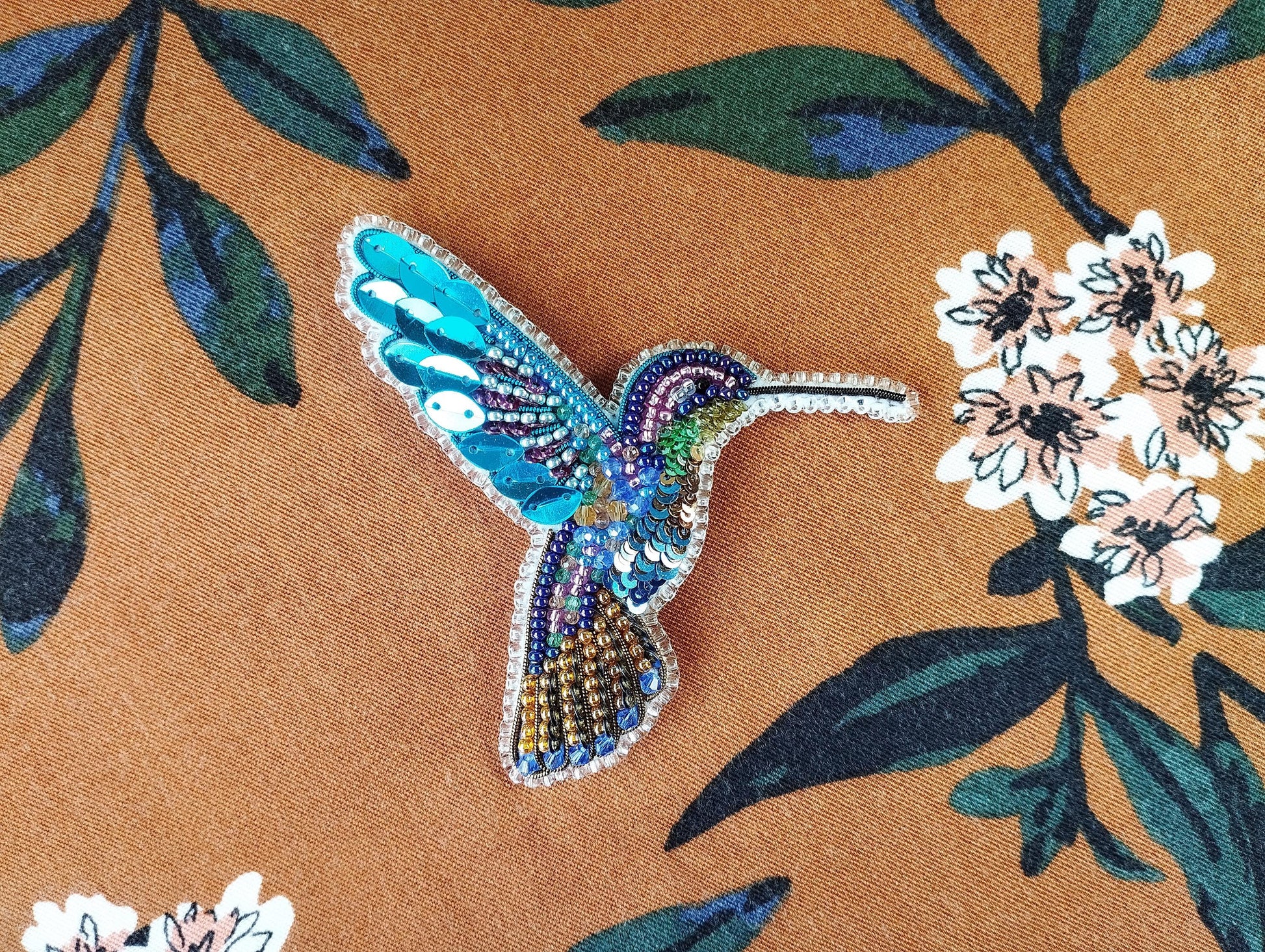 a picture of a hummingbird on a floral background