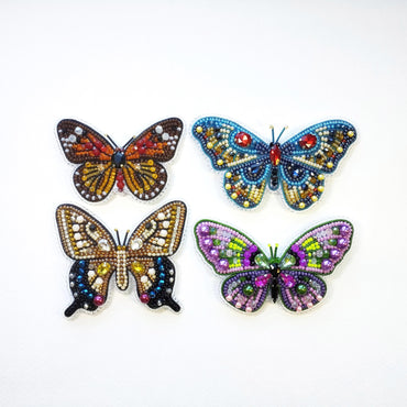 a group of three butterflies sitting on top of a white surface