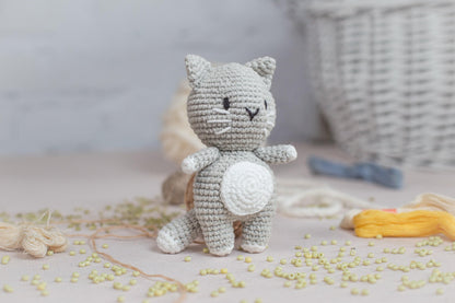 a small crocheted cat sitting on a table